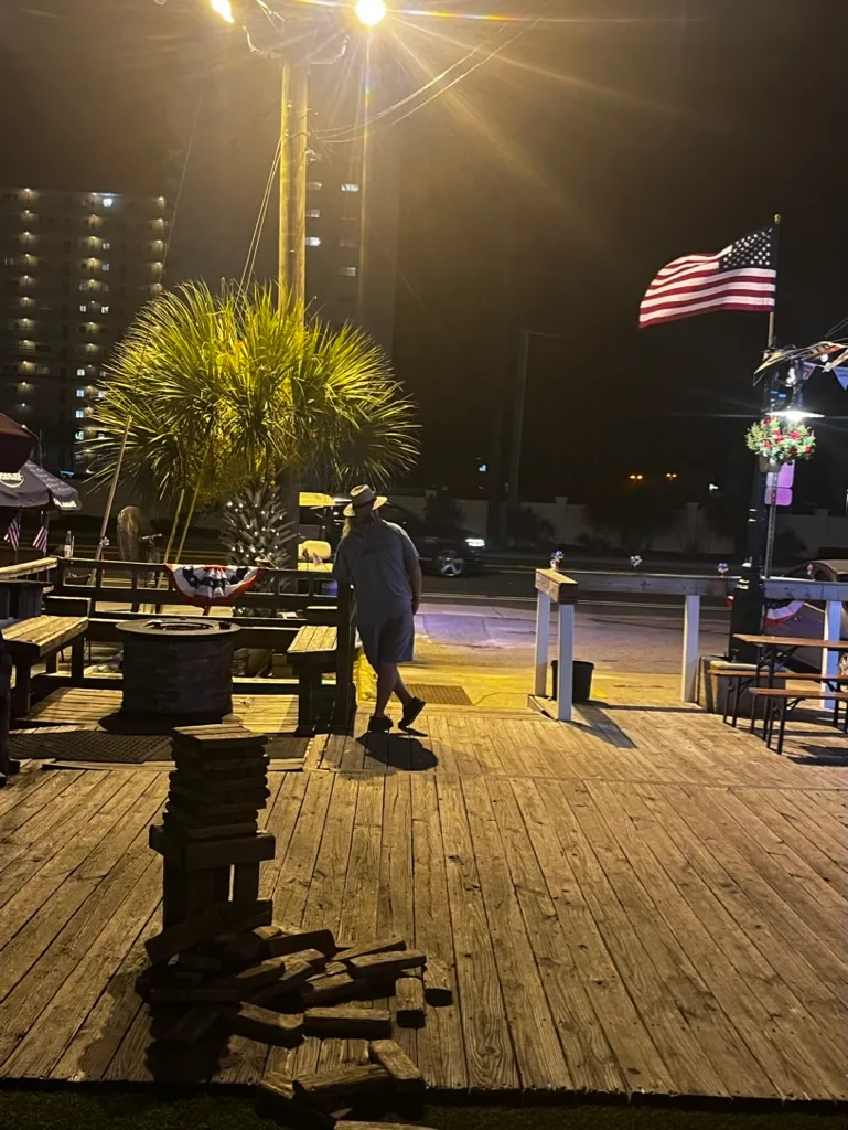 Buster's patio at night with American flag and Jenga game